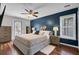 Comfortable bedroom with blue accent wall, ceiling fan, and natural light at 3651 Barton St, Johns Island, SC 29455