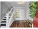 Bright entryway with hardwood floors, modern staircase, and stylish decor at 3651 Barton St, Johns Island, SC 29455
