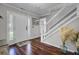 Inviting entryway with dark wood floors, a white door, and modern staircase at 3651 Barton St, Johns Island, SC 29455