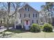 Charming two-story home with blue shutters, a red door, and mature trees providing shade at 3651 Barton St, Johns Island, SC 29455