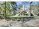 Back exterior view of a charming home with a large backyard, deck and stairs at 3651 Barton St, Johns Island, SC 29455