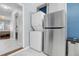 Bright kitchen with stainless steel refrigerator, in-unit washer and dryer, with marble floors and blue walls at 3651 Barton St, Johns Island, SC 29455