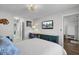 Comfortable bedroom featuring hardwood floors, a TV, and a view into the en-suite bathroom at 3651 Barton St, Johns Island, SC 29455
