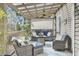 Inviting covered patio with stylish furniture, overhead fan, and privacy screen at 3651 Barton St, Johns Island, SC 29455