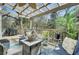 Relaxing covered patio with comfortable seating, ceiling fan, and a view of greenery at 3651 Barton St, Johns Island, SC 29455