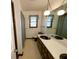 Bathroom featuring a large mirror, sink, and window with a curtain at 388 Benton Farm Rd, Walterboro, SC 29488