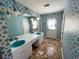 Unique bathroom featuring double sinks, floral wallpaper, and a door leading to the exterior at 388 Benton Farm Rd, Walterboro, SC 29488