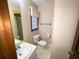 Small bathroom with a tiled floor, standard toilet, sink, and a window with blinds and a valance at 388 Benton Farm Rd, Walterboro, SC 29488