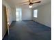 Bedroom with a ceiling fan featuring natural light from the windows and a door leading to the bathroom at 388 Benton Farm Rd, Walterboro, SC 29488