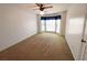 Bedroom features neutral carpet, a ceiling fan, and a bay window with curtains at 388 Benton Farm Rd, Walterboro, SC 29488