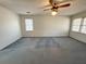 Spacious bedroom with two windows and a ceiling fan provides natural light, ready for updates at 388 Benton Farm Rd, Walterboro, SC 29488