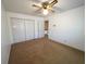 Bedroom featuring neutral carpet, a ceiling fan, and a closet with folding doors at 388 Benton Farm Rd, Walterboro, SC 29488