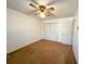 Bedroom with neutral carpet, ceiling fan, and closet, offering a versatile space for relaxation and storage at 388 Benton Farm Rd, Walterboro, SC 29488