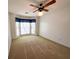 Bedroom features neutral carpet, a ceiling fan, and a bay window with curtains at 388 Benton Farm Rd, Walterboro, SC 29488