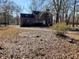 Back of brick house with mature landscaping and bare trees on a sunny day at 388 Benton Farm Rd, Walterboro, SC 29488