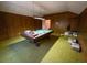 Recreation room featuring wood paneling, green carpet, and a pool table at 388 Benton Farm Rd, Walterboro, SC 29488