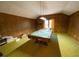 Recreation room featuring wood paneling, green carpet, and a pool table at 388 Benton Farm Rd, Walterboro, SC 29488