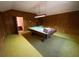 Recreation room featuring wood paneling, green carpet, and a pool table at 388 Benton Farm Rd, Walterboro, SC 29488