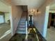 Hallway with unique floor tiles leading to carpeted stairs and adjacent rooms at 388 Benton Farm Rd, Walterboro, SC 29488