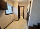 Hallway with linoleum floors leads to a bathroom and stairs at 388 Benton Farm Rd, Walterboro, SC 29488