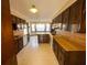 Spacious kitchen with dark wood cabinets and updated appliances on a vinyl floor at 388 Benton Farm Rd, Walterboro, SC 29488