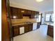 This kitchen features wood cabinetry, laminate counters and flooring, and white appliances at 388 Benton Farm Rd, Walterboro, SC 29488