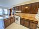 Traditional kitchen features stained wood cabinets, laminate countertops, and white appliances at 388 Benton Farm Rd, Walterboro, SC 29488