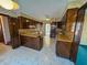 Expansive kitchen has stained wood cabinets, laminate countertops, and white flooring at 388 Benton Farm Rd, Walterboro, SC 29488