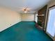 Bright living room with fireplace, large windows, and green carpet at 388 Benton Farm Rd, Walterboro, SC 29488