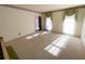 Large living room with carpet and large windows, and doorway to other rooms at 388 Benton Farm Rd, Walterboro, SC 29488