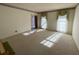 Spacious living room featuring carpet flooring, natural light, and a view to the hallway at 388 Benton Farm Rd, Walterboro, SC 29488