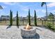 Outdoor oasis boasting a stone fire pit, picturesque pond view, and manicured landscaping, creating a serene and inviting atmosphere at 3920 Maidstone Dr, Mount Pleasant, SC 29466