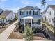 Two-story home with welcoming front porch, complimented by manicured landscaping at 3920 Maidstone Dr, Mount Pleasant, SC 29466