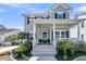 Charming two-story home with a classic covered porch and beautiful landscaping at 3920 Maidstone Dr, Mount Pleasant, SC 29466