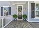 Inviting front porch with decorative door, potted plants, and stylish outdoor lighting at 3920 Maidstone Dr, Mount Pleasant, SC 29466