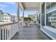 View from porch, showing columns, wood flooring, and residential street at 3920 Maidstone Dr, Mount Pleasant, SC 29466