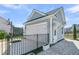 Detached garage boasts a white door, coach lights and private fenced yard at 3920 Maidstone Dr, Mount Pleasant, SC 29466