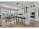 Bright kitchen with white cabinets, stainless steel appliances, island with barstool seating, and adjacent dining area at 3920 Maidstone Dr, Mount Pleasant, SC 29466