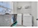 Functional laundry room with washer, dryer, storage baskets, and a bright window, providing a convenient and tidy space at 3920 Maidstone Dr, Mount Pleasant, SC 29466