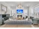 Spacious living room with gray sofas, fireplace, TV and piano creating a comfortable and inviting space at 3920 Maidstone Dr, Mount Pleasant, SC 29466