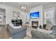 Cozy living room featuring gray sofas, a fireplace with a TV, and piano, perfect for entertaining or relaxing at 3920 Maidstone Dr, Mount Pleasant, SC 29466