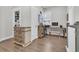 Bright office space with a wooden desk, shelves, and a charming dresser featuring decorative details, perfect for a functional and stylish workspace at 3920 Maidstone Dr, Mount Pleasant, SC 29466