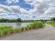 Scenic walking path by the pond with lush greenery, offering residents a serene environment for leisure and recreation at 3920 Maidstone Dr, Mount Pleasant, SC 29466