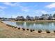 Beautiful view of a serene pond surrounded by lush landscaping and homes at 3920 Maidstone Dr, Mount Pleasant, SC 29466