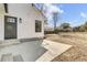 Back of the house with a concrete patio, black door, and minimal landscaping at 397 Parkdale Dr, Charleston, SC 29414