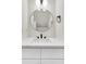 Bathroom vanity with a round mirror, modern faucet, and quartz countertop at 397 Parkdale Dr, Charleston, SC 29414