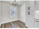 Eat-in kitchen space with natural light, pendant lighting, wood-look floors, and white cabinets at 397 Parkdale Dr, Charleston, SC 29414