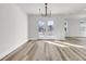 Bright dining room with pendant lighting, wood-look flooring and access to a fenced-in backyard at 397 Parkdale Dr, Charleston, SC 29414