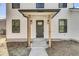 Close up of home's front door, featuring a modern design with wood columns and a decorative glass window at 397 Parkdale Dr, Charleston, SC 29414