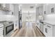 Bright kitchen features white cabinetry, stainless appliances, and tile backsplash at 397 Parkdale Dr, Charleston, SC 29414